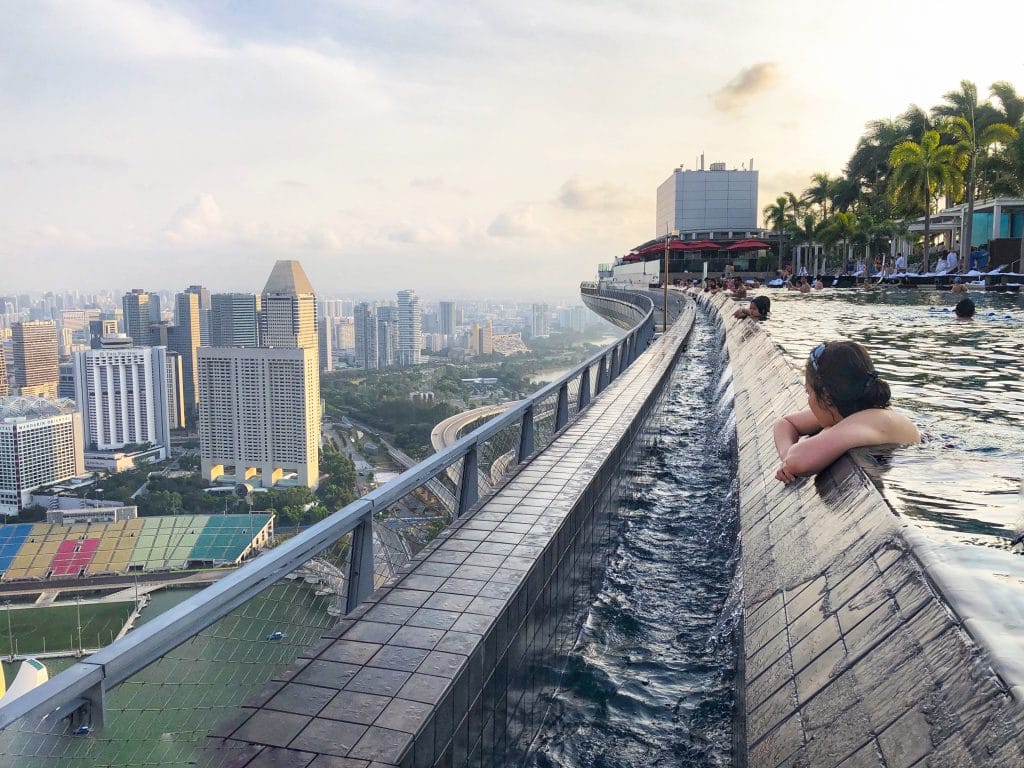 A girl swimming at the rooftop infinity pool on top of the Marina Bay Sands Singapore.