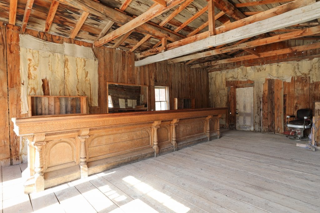 A large, wooden bar inside an old saloon.