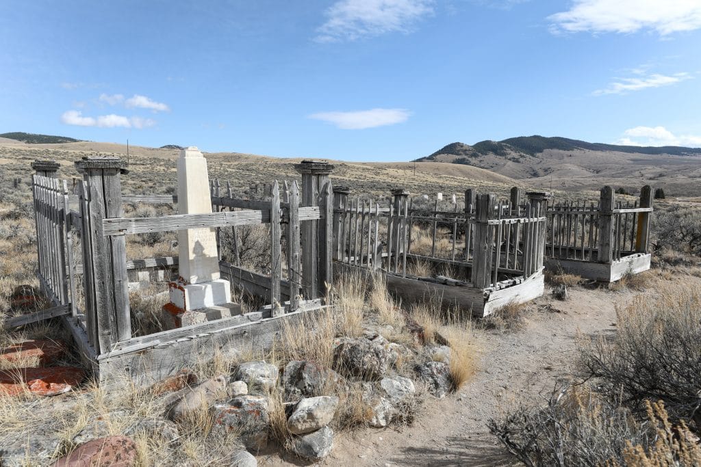 A cemetery with multiple headstones.