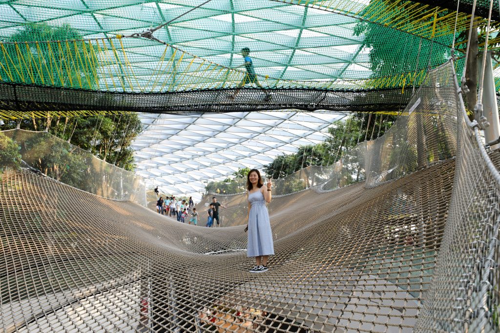 A woman waving on the Sky Nets inside Jewel at Changi Airport in Singapore. #changiairport #canopypark