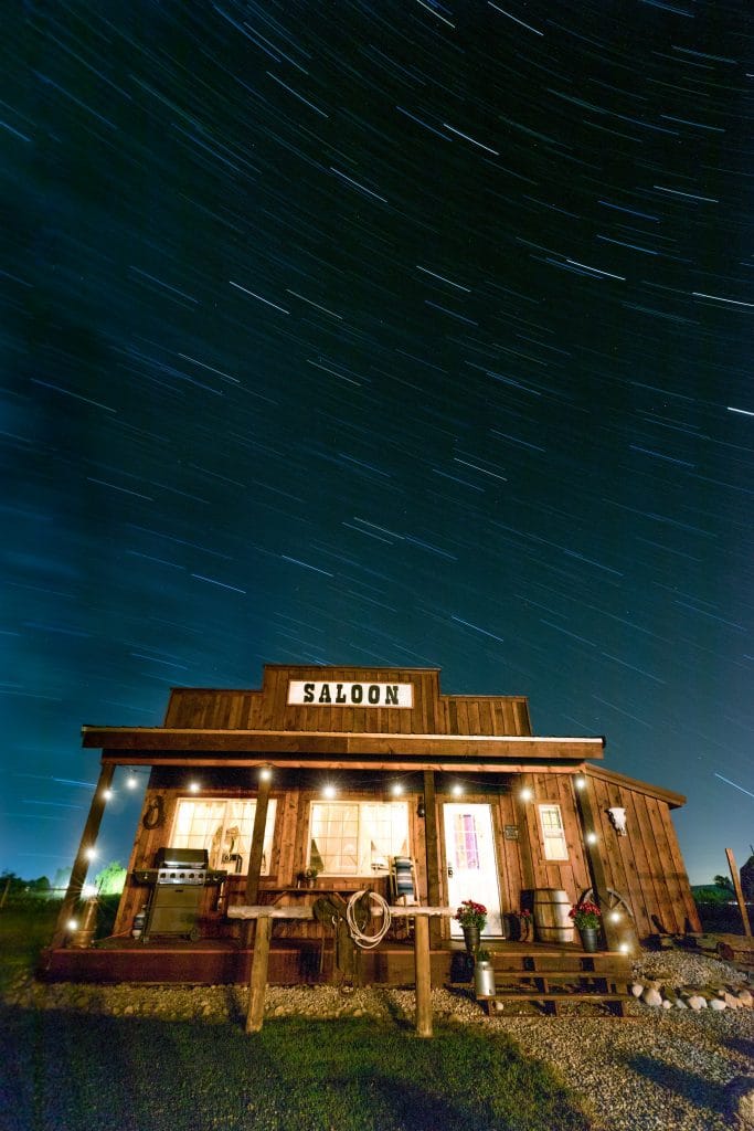 An old west saloon at night surrounded by star trails. One of the most picturesque moments of 2020.