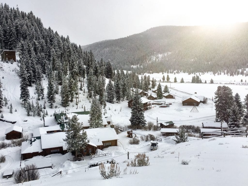 The snowy 320 Guest Ranch as seen from the top of a nearby hill. #320guestranch