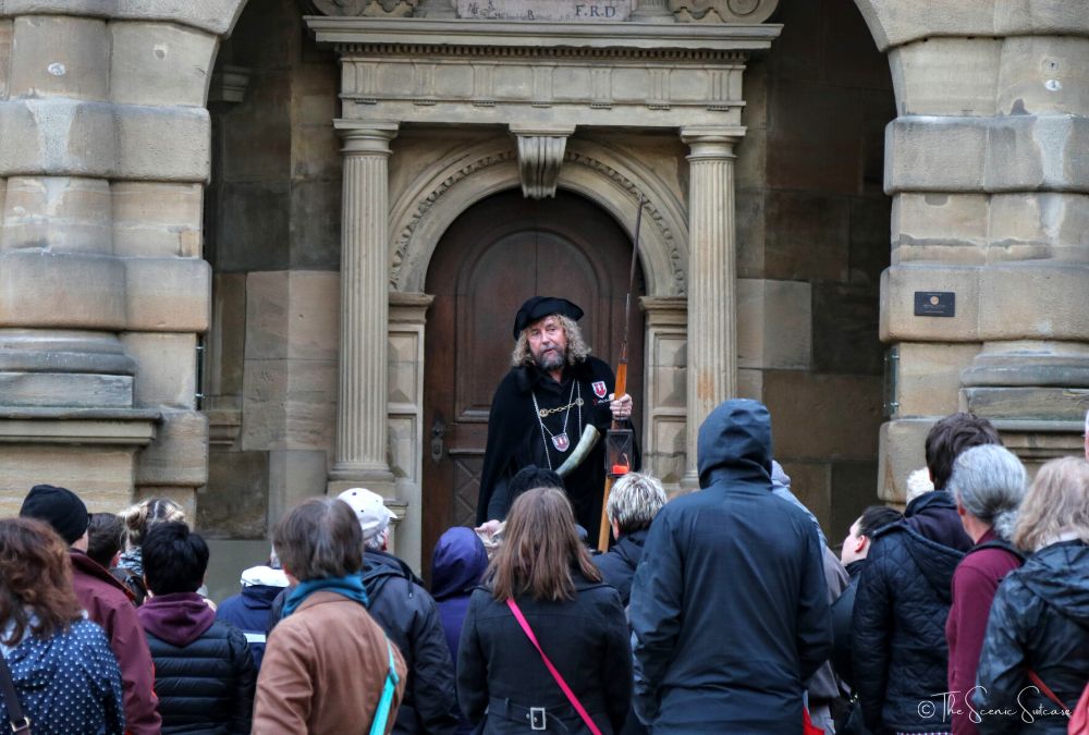 A man dressed as a night watchman giving a group of people a tour. Discover why Rothenburg ob der Tauber in Germany is a must for your fairytale bucket list (and what you can't miss while you're there!)