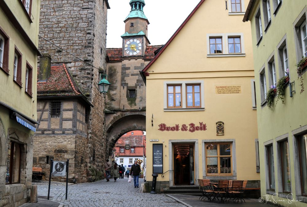 A yellow bakery along a cobblestone street. Discover why Rothenburg ob der Tauber in Germany is a must for your fairytale bucket list (and what you can't miss while you're there!)