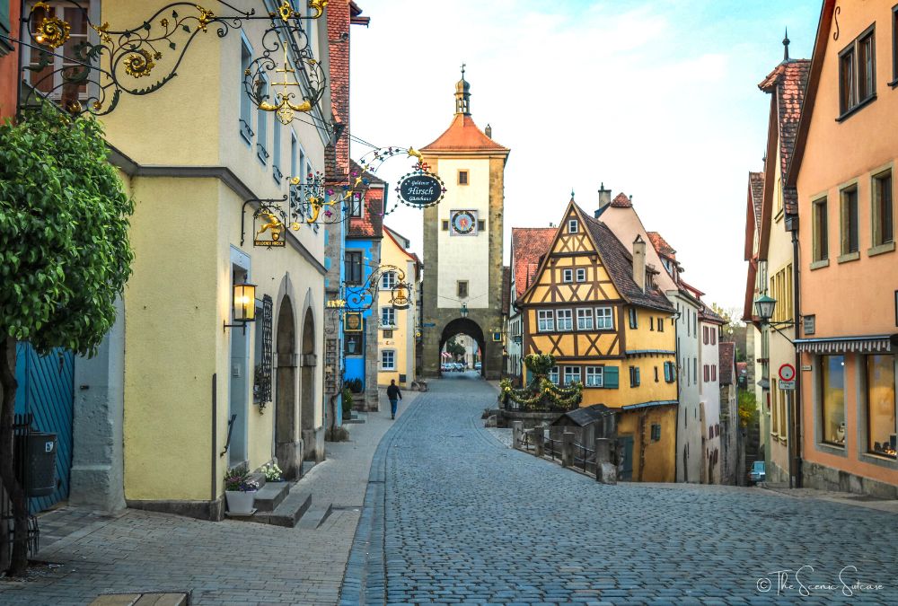 A germany cobblestone street that looks like something from a Disney movie. Discover why Rothenburg ob der Tauber in Germany is a must for your fairytale bucket list (and what you can't miss while you're there!)