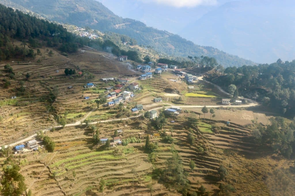 A bird's eye view of a small Nepali village from a helicopter.
