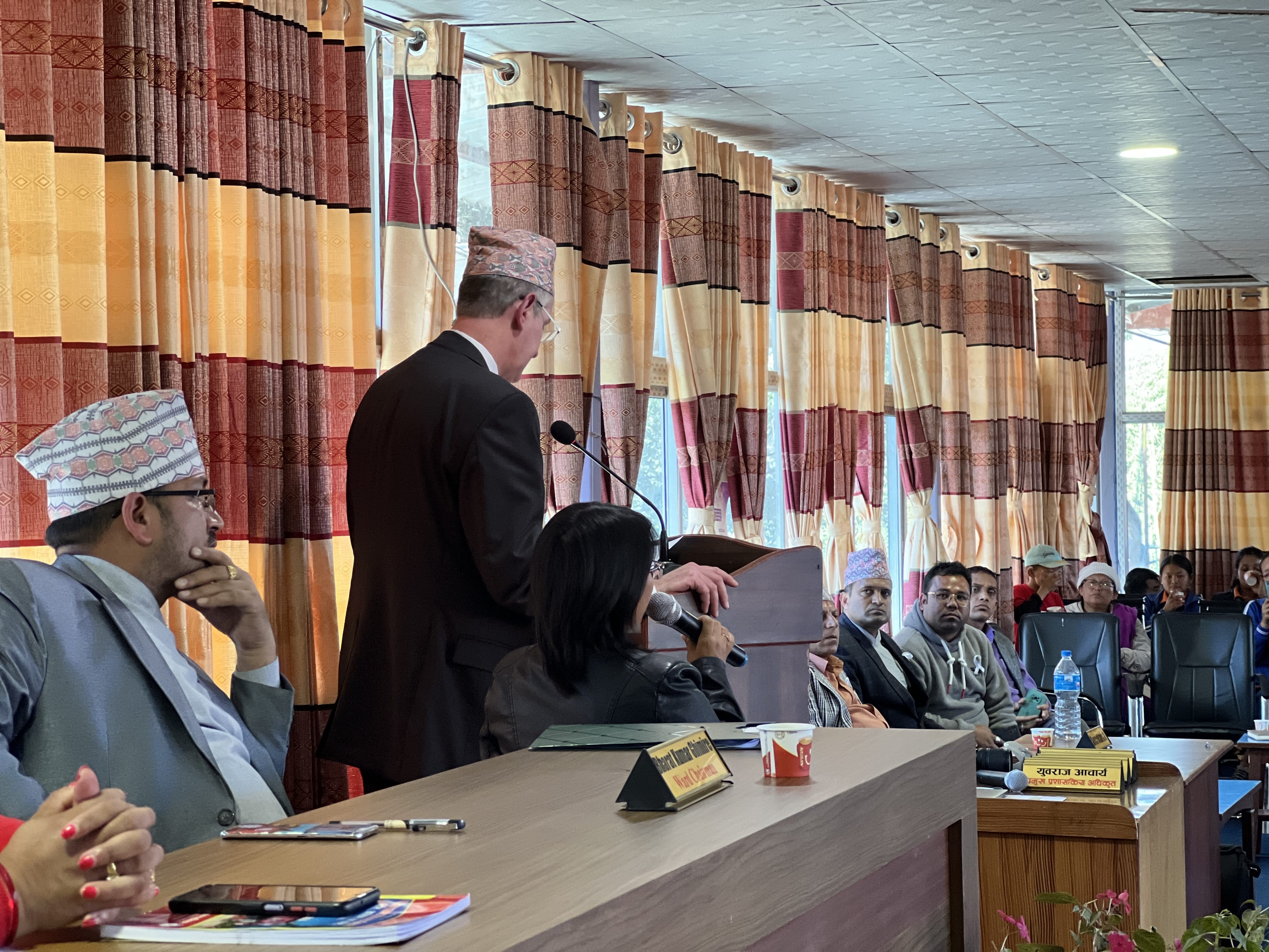 A man speaking to a group at the municipality building in Khandbari, Nepal.