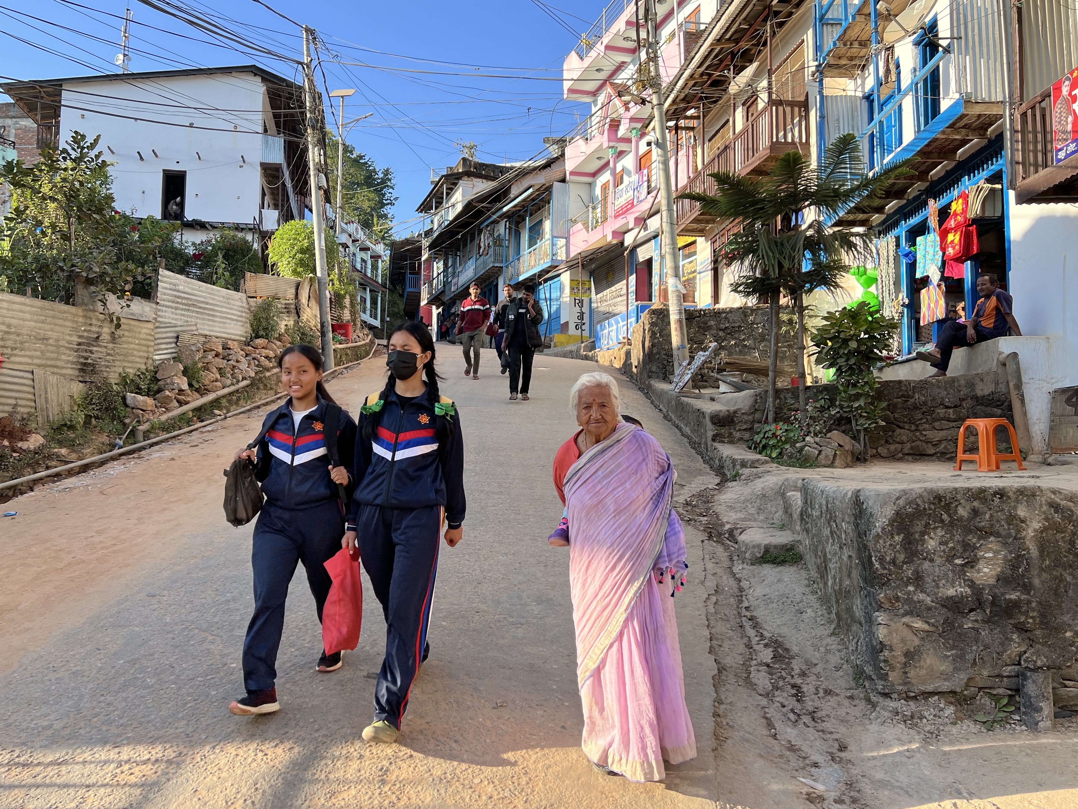 People walking the streets along a hill in Khandbari, Nepal.