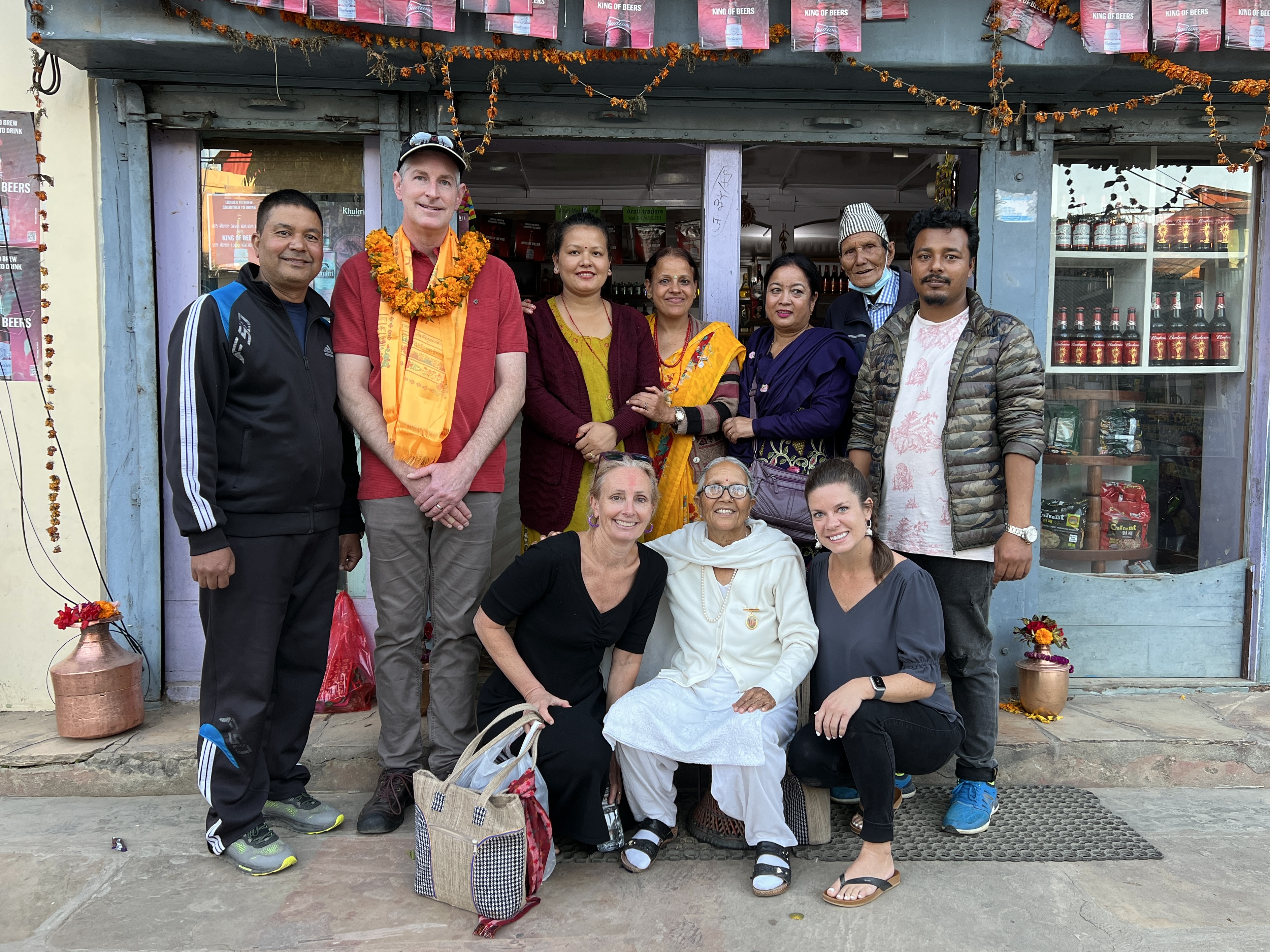Poeple standing outside a shop in Nepal.