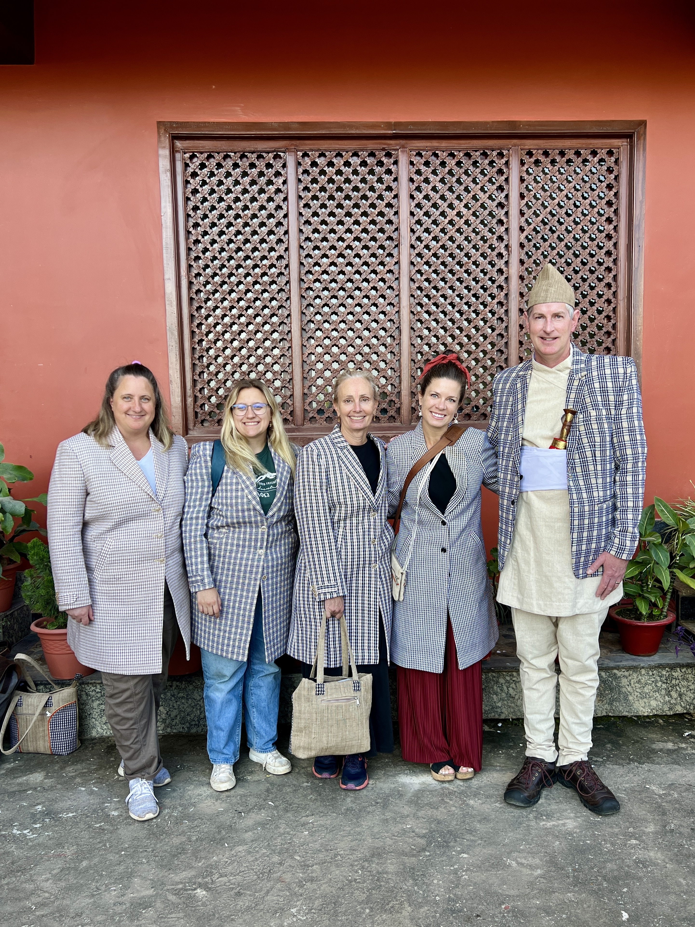 A group of five people wearing tailored winter jackets.
