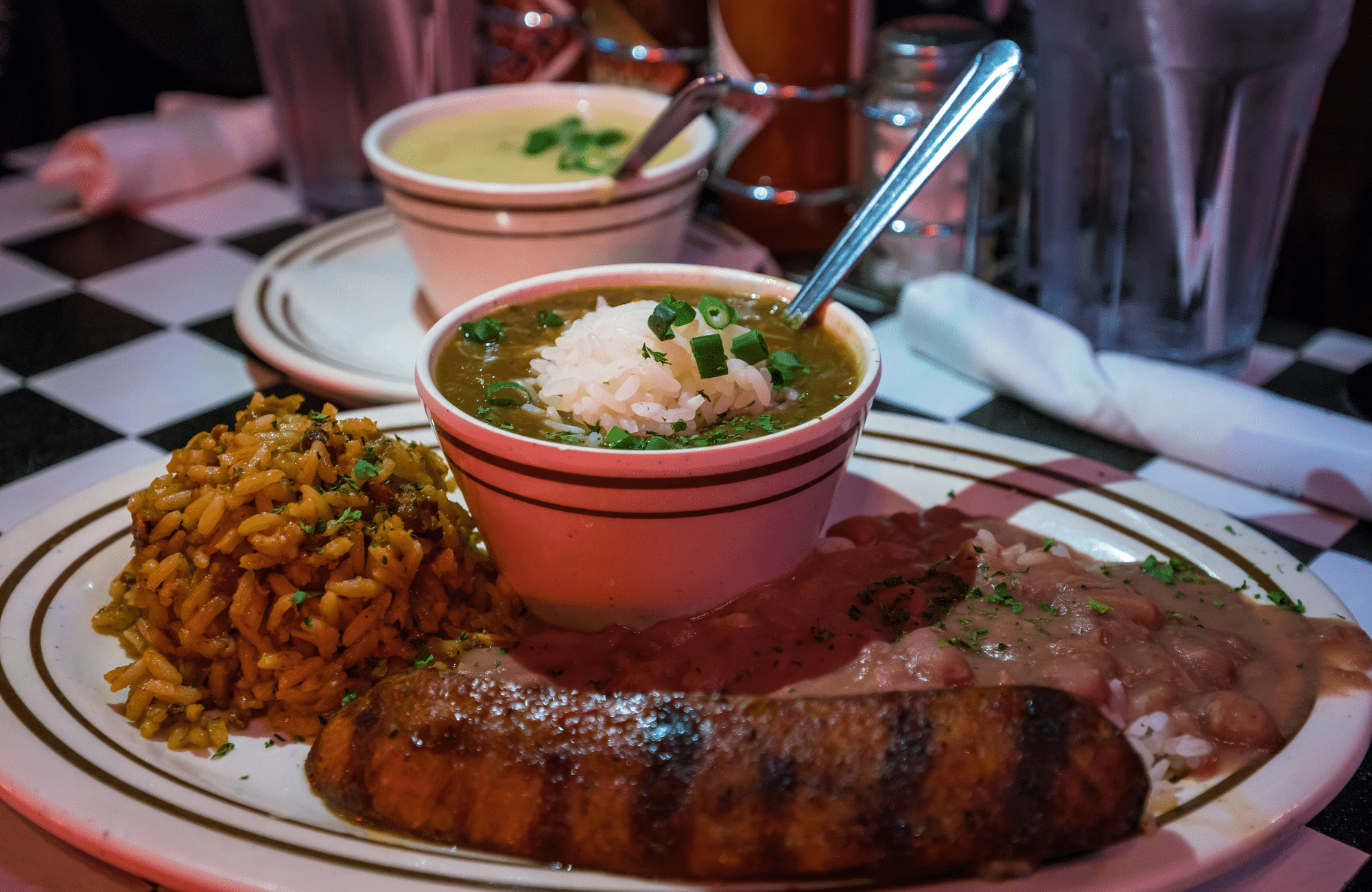 Sausage and rice on a brown striped plate.