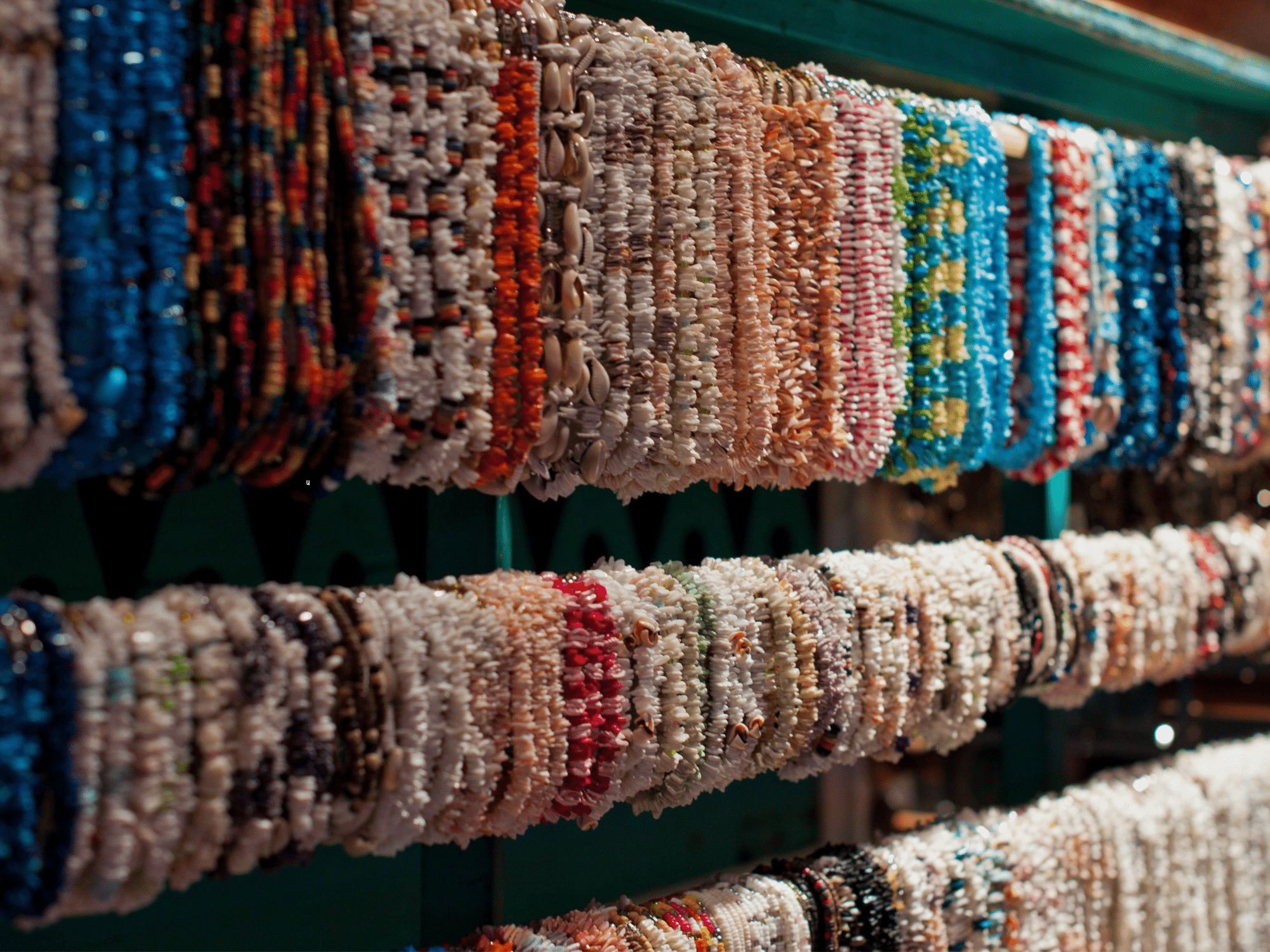Stone necklaces hung in a row.
