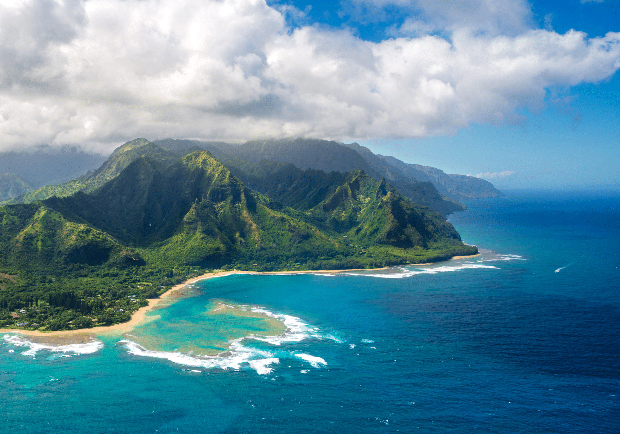 An aerial view of a Hawaiian island surrounded by bright blue waters.